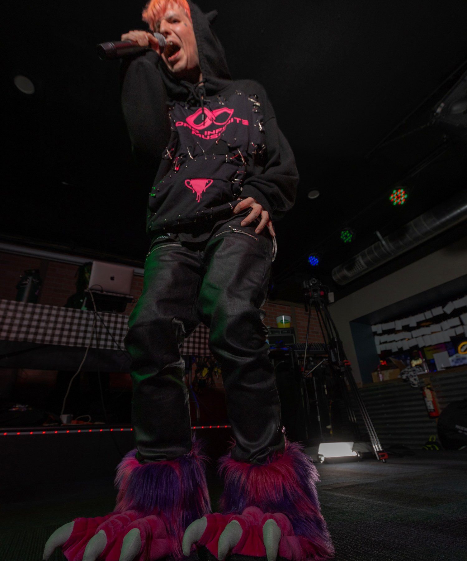Lord Infinit3 performing with hot pink hair and monster-claw boots